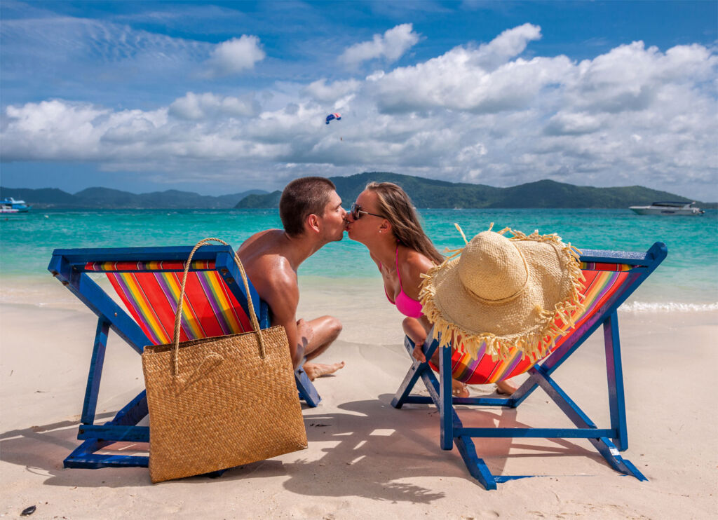 A couple sharing a kiss on a Caribbean beach