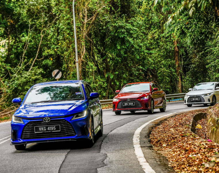 The convoy of cars being driven through the lush forest in the Genting Highlands