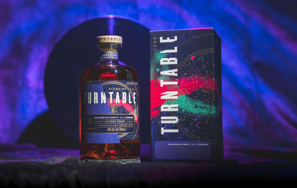 A bottle of the Turntable Collaboration Drop 01 With Starward next to its multi-coloured box