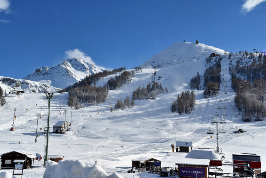 Traditional lodges framed by snow covered mountains