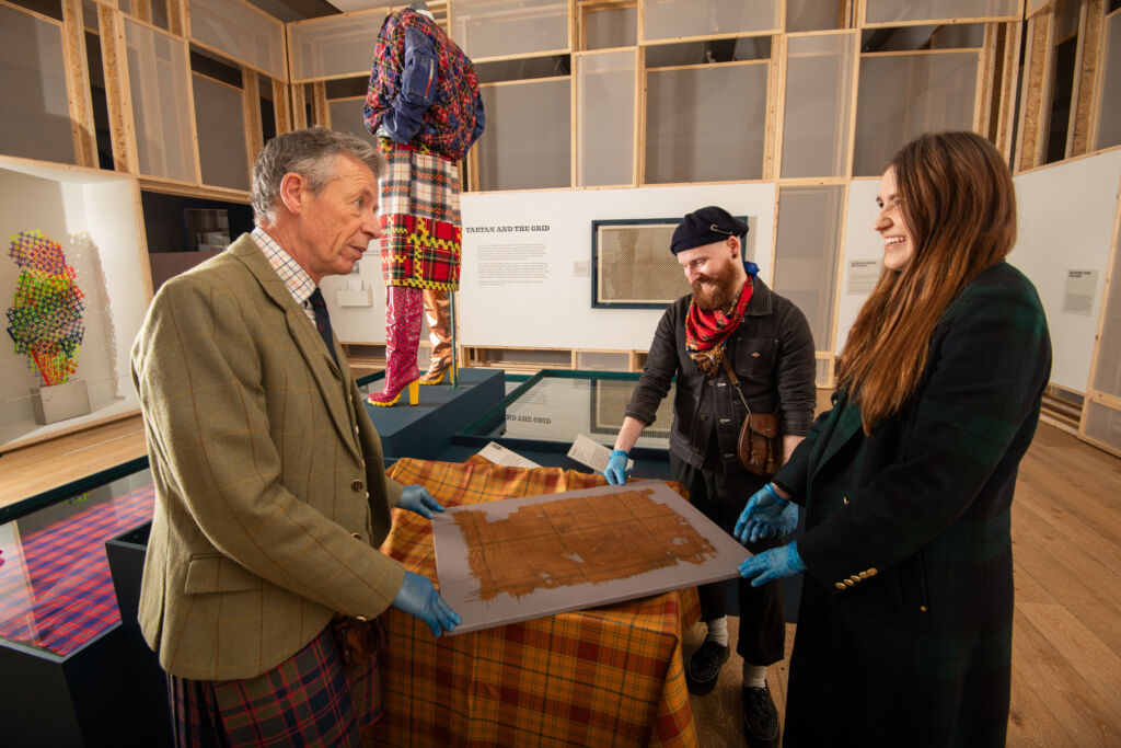 Emma, Peter and James discussing the Tartan