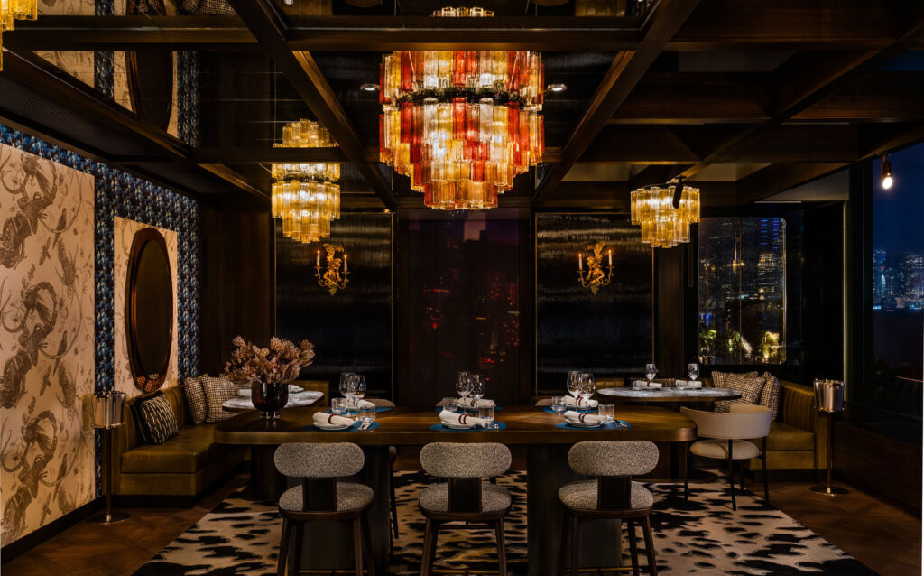 Qura Bar Opens Bringing a Sensory Odyssey, Rare Spirits and Hypnotic Views 12 One of the large dining tables inside the eclectic-designed bar