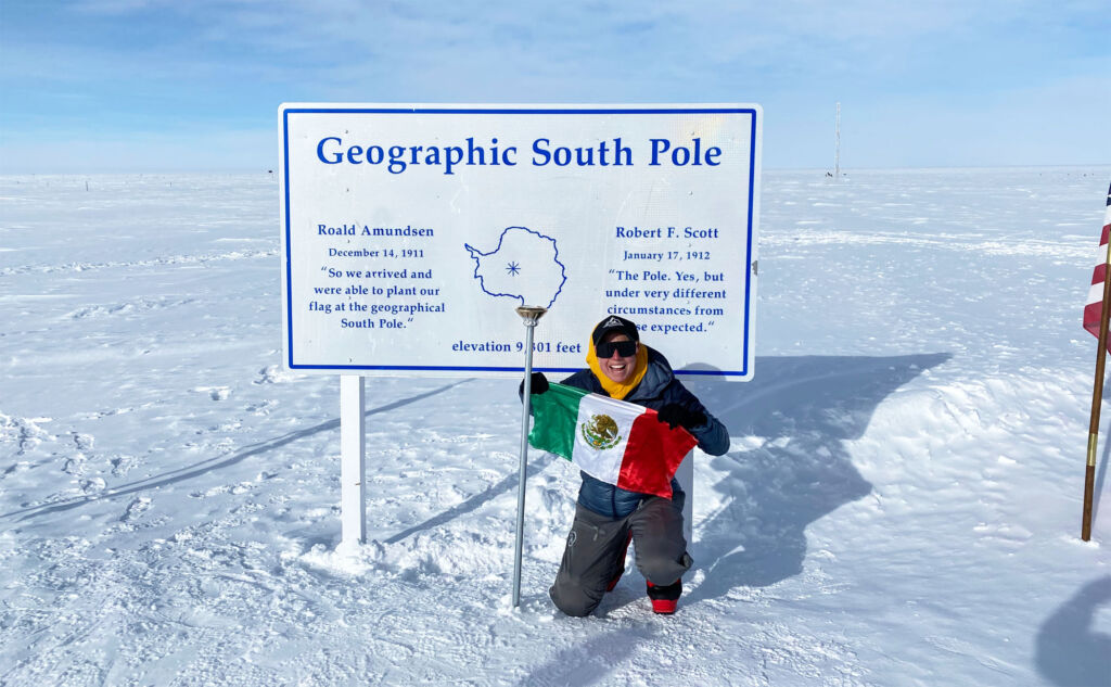 Andy holding up the Mexican Flag at the Geographic South Pole