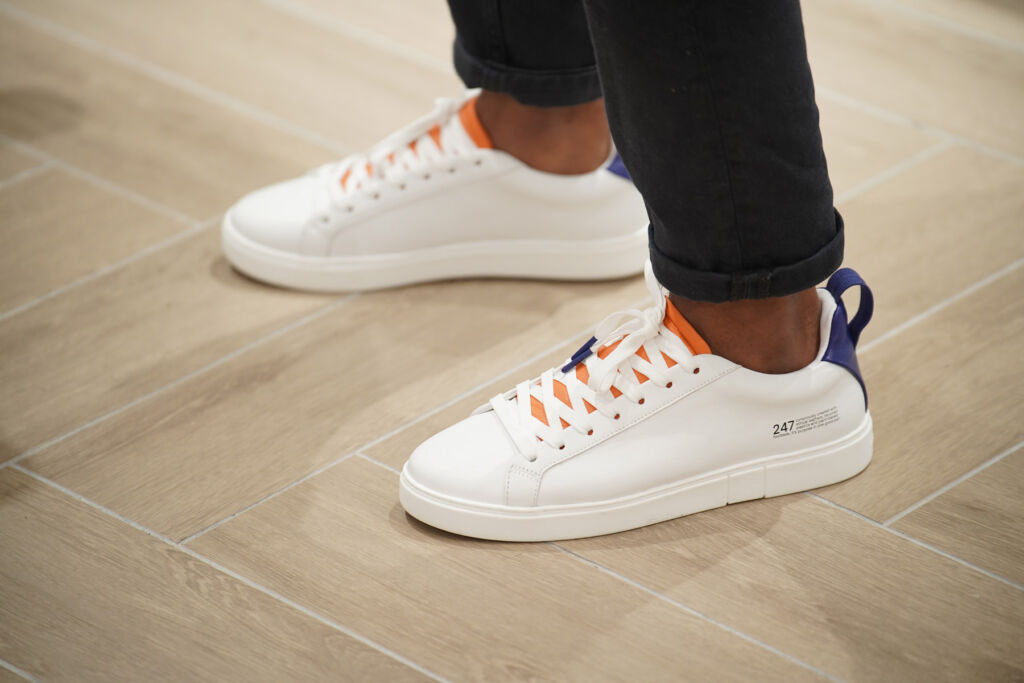 A model wearing a pair of the company's white sneakers