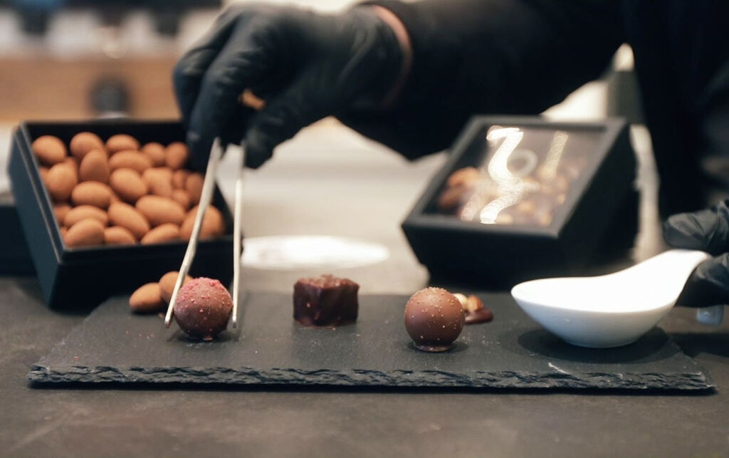 Hand crafted chocolates being picked up with tweezers