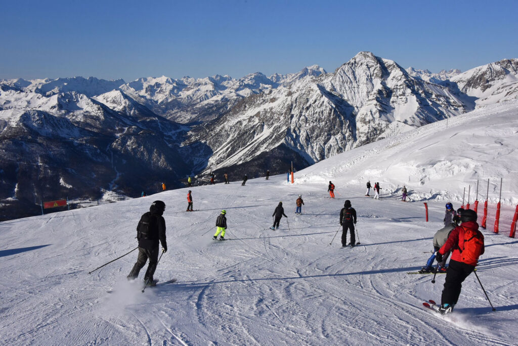 Skiers heading down a gentle slope