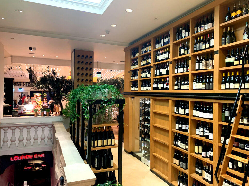 The wooden shelves inside the restaurant hosting a vast collection of wines