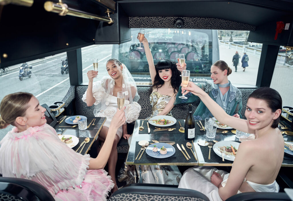 Jessica and the models celebrating the shows on a luxury coach