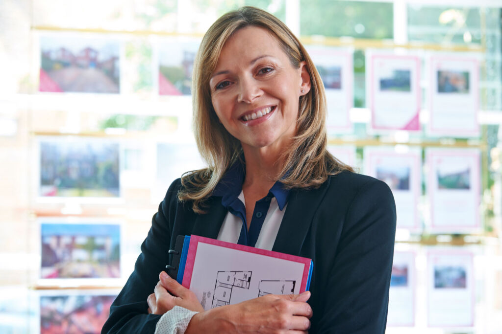 A female estate agent standing in her office
