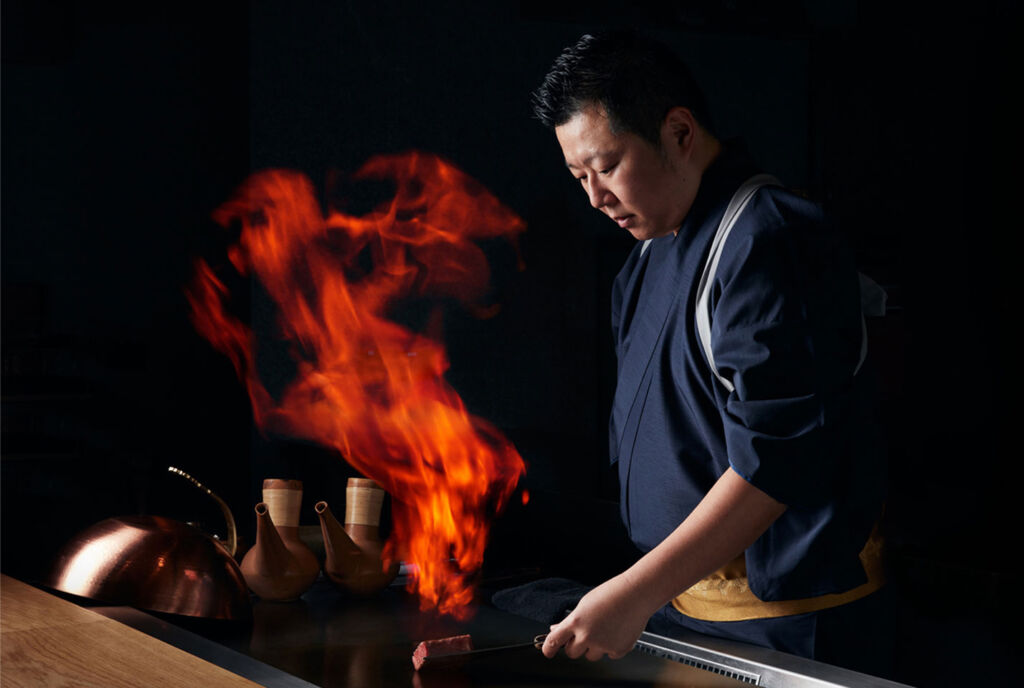 Yoshiyuki Sato grilling a cut of beef