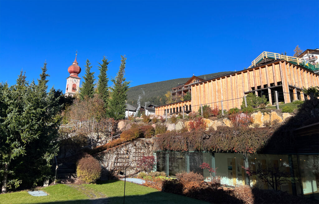 A view of the property's exterior on a clear sunny day with the mountains in the background