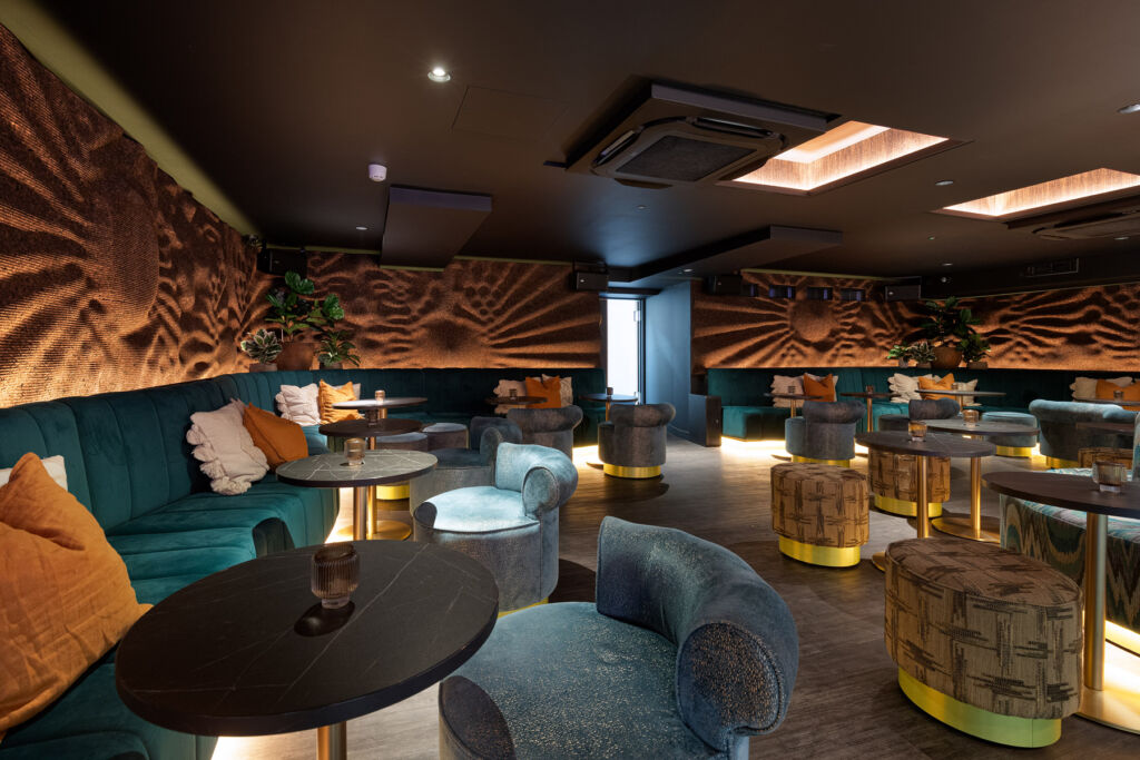 A photograph showing the plush lounge area inside the bar