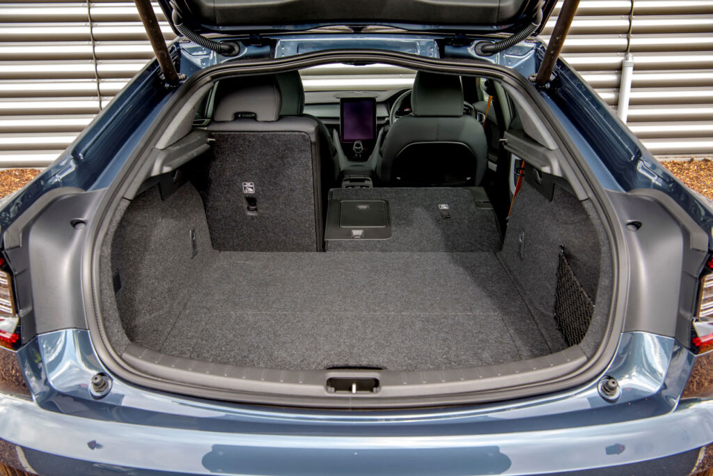 A photograph of the boot area with one of the seats folded down almost flat
