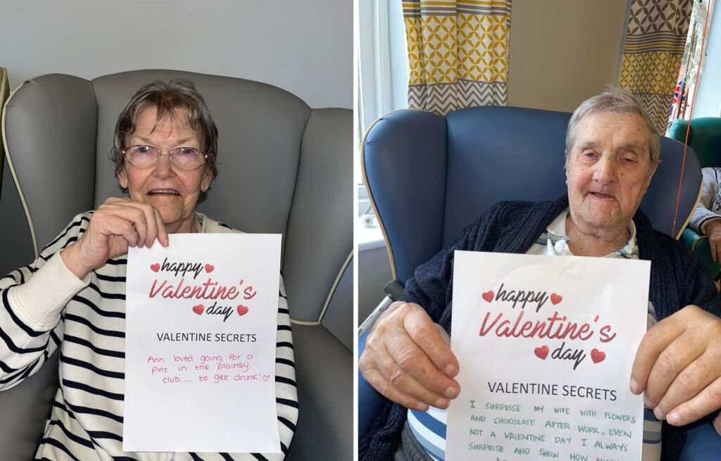 Two of the residents holding their Valentine's Day memories, written on specially printed paper