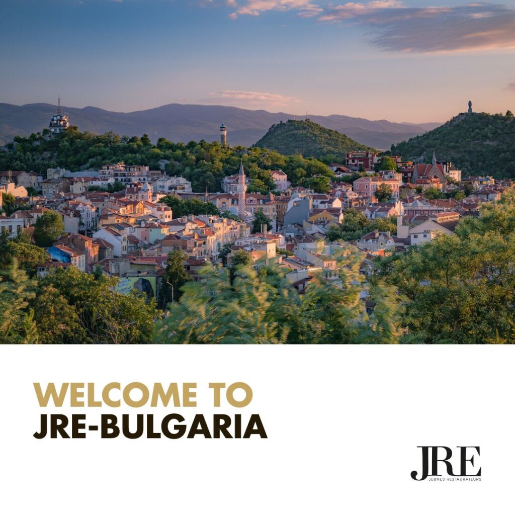 An aerial view of a Bulgarian town on a welcome poster from JRE