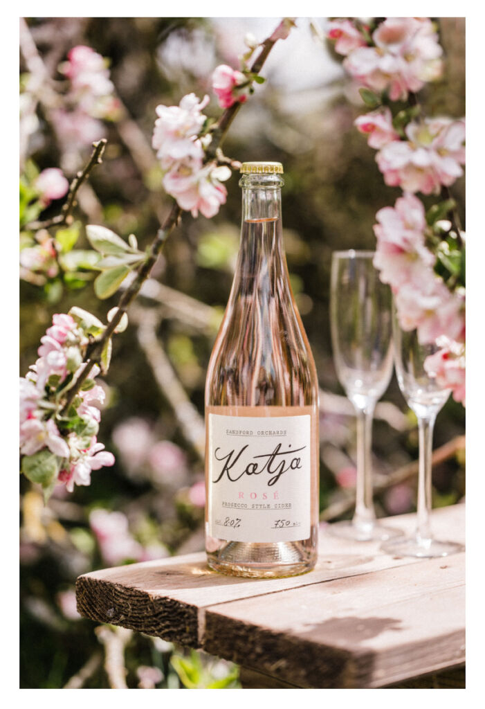 A bottle of Katja Rose outdoors on a wooden table