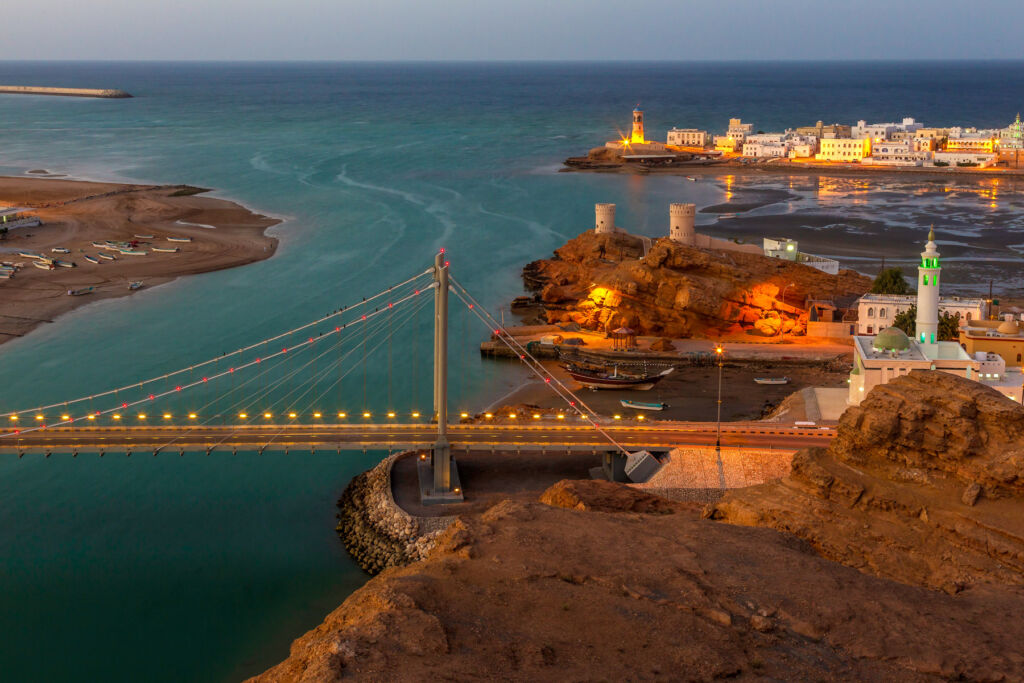 An aerial view of a bridge in Sur at night