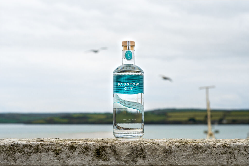 A bottle of the gin places on top of the sea wall