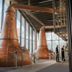 Distillery workers next to the new copper stills