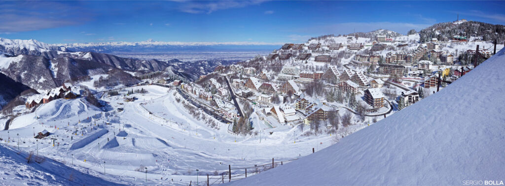 Food and Adventure in Cuneo and Turin at the Foot of The Piedmont Alps 23 An aerial view of a variety of accommodations on the side of the mountains