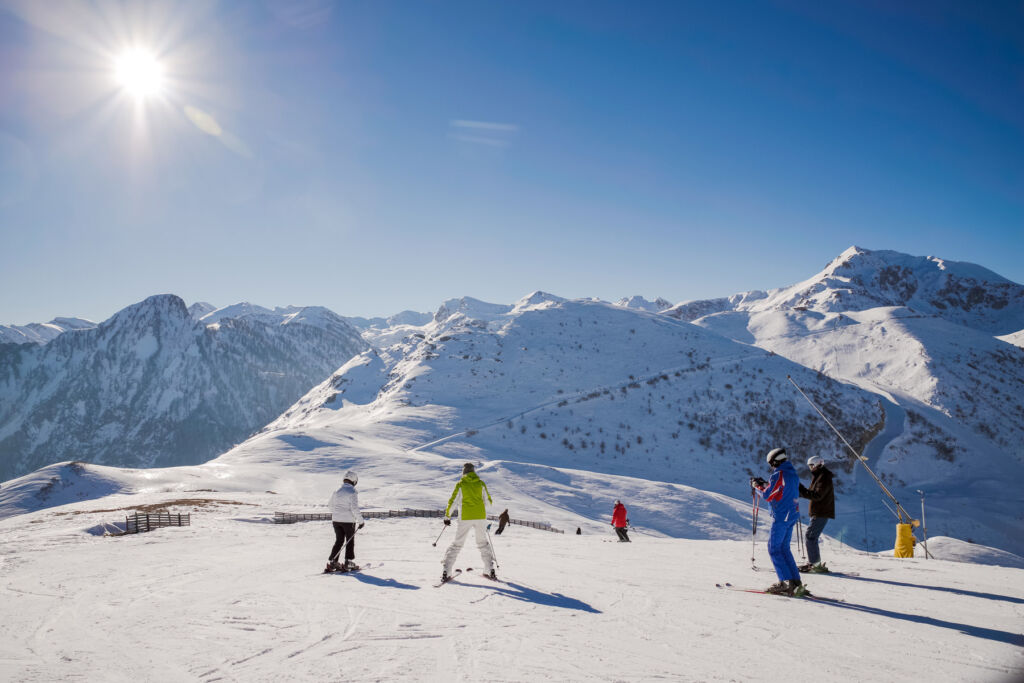 Skiers on the top of the snow covered mountains