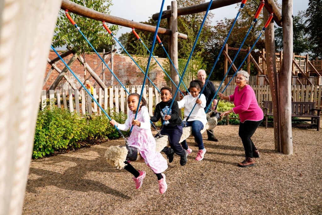 Adults and children having fun with a swing