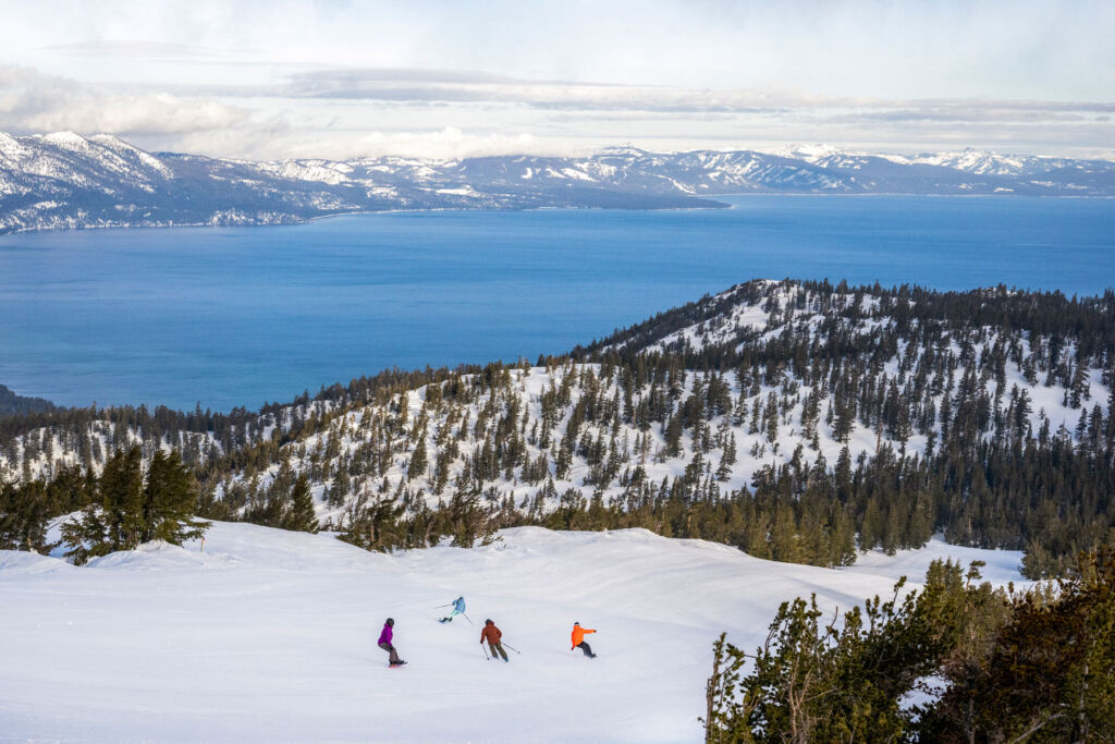Skiers heading down the snowy slopes in South Lake Tahoe