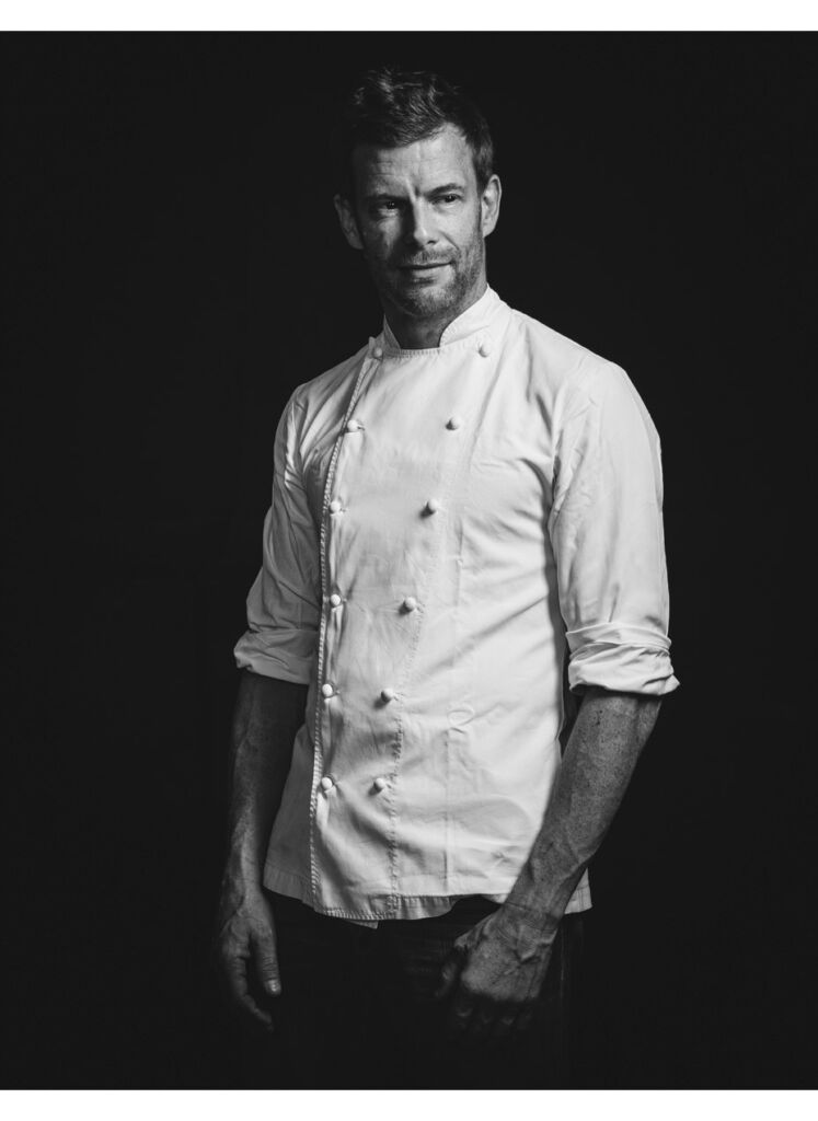 A black and white photo of Chef Tom