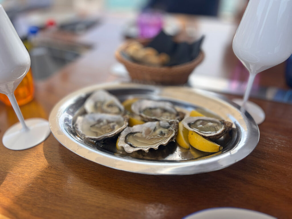 A plate of fresh oysters with slices of lemon