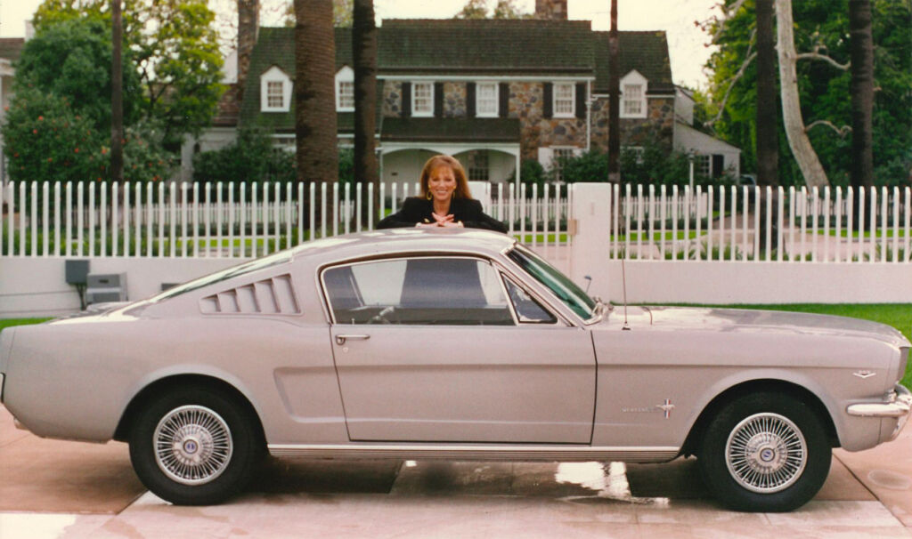Jackie Collins next to her Mustang