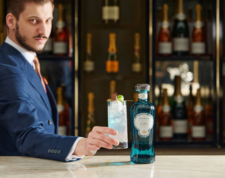 A bartender holding the new cocktail