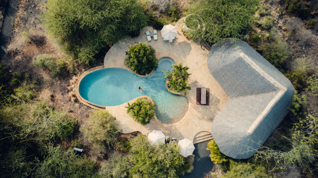 An aerial photograph of one of the luxury lodges with its pool