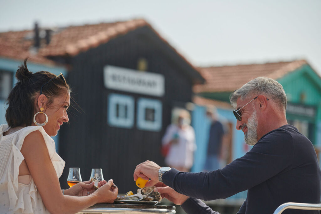 A couple enjoying food by the river