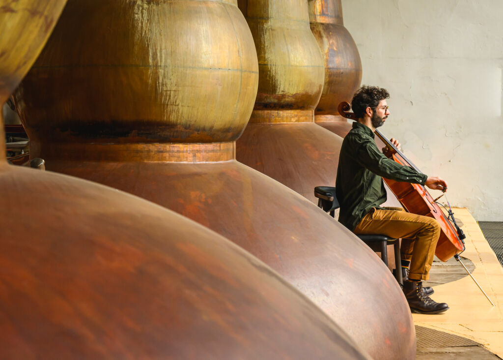 ‘Valley of the Brambles’, Where The Glendronach’s Whisky and Music Intertwine 11 A side view of Rob playing the cello next to the whisky stills