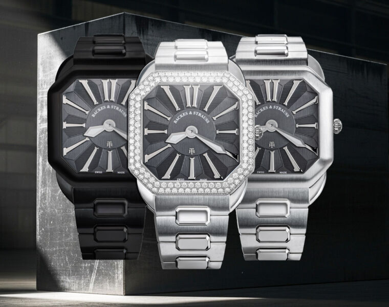 The three models in front of a block of anthracite coloured steel