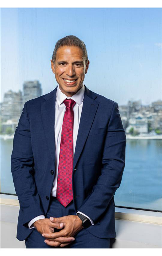 From Fragmentation to Flourishing, The New Architecture of Belonging 8 A photograph of a suited Mohamed Amer