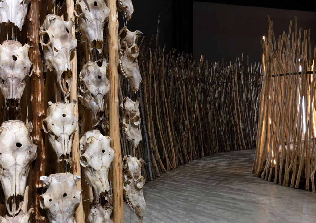 A photograph of part of the exhibition which shows reindeer skulls interwoven with natural materials