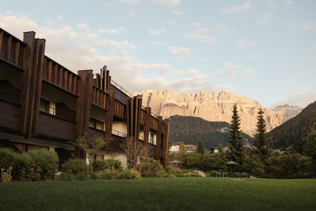 Why the Dolomites and Hotel Granbaita Are the Perfect Couples Retreat 12 The exterior of the hotel with the mountains in the background