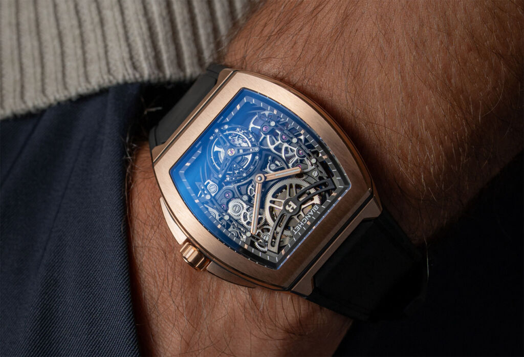 The gold timepiece being worn on the wrist