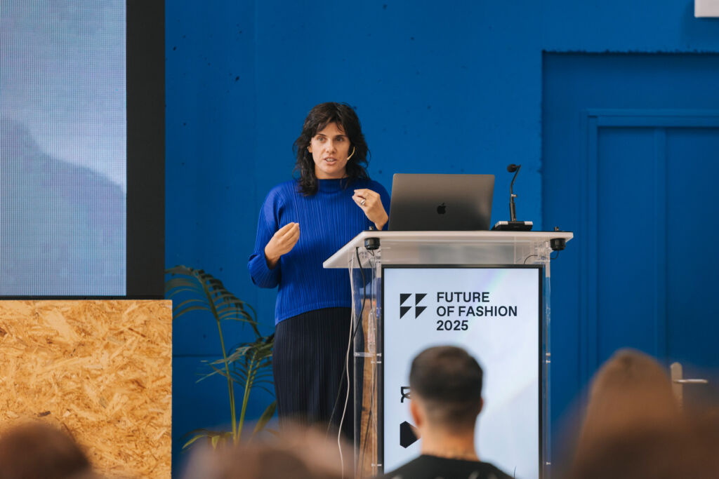 The Future of Fashion 2025: A New Era of Sustainability and Innovation 13 Faustine talking to the audience from the podium