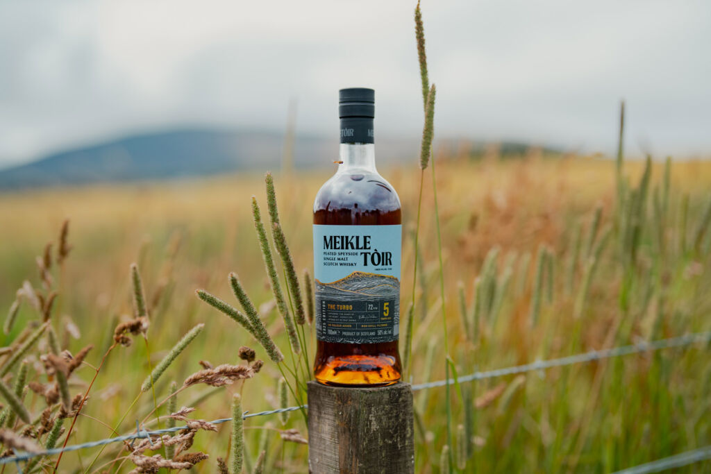 The Luxurious Magazine Whisky Industry News Round-up for October 2025 19 A bottle of Meikle Tòir balanced on top of a wooden fence post