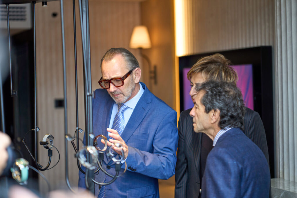 Three experts admiring the watches on display