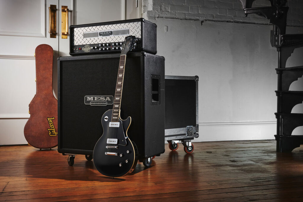 The guitar laid against a large amplifier