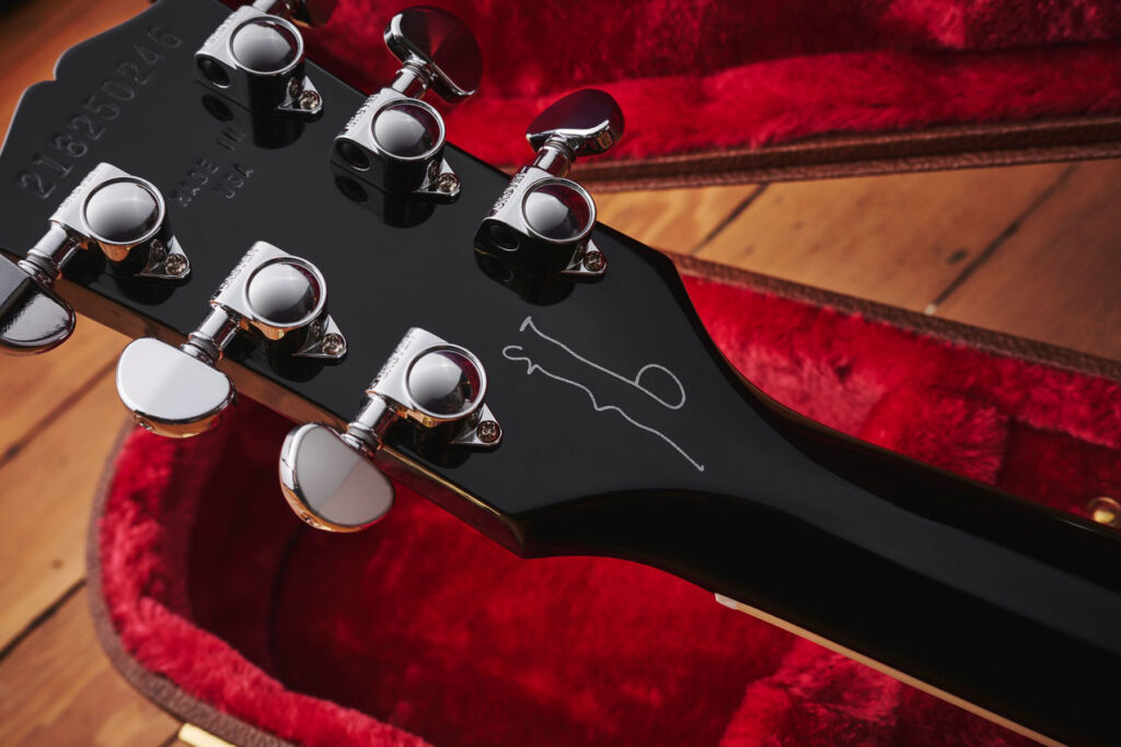 Gallagher's signature on the headstock in silver