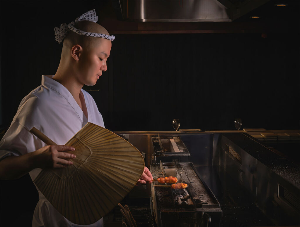 Chef Ryo Matsui preparing a skewer