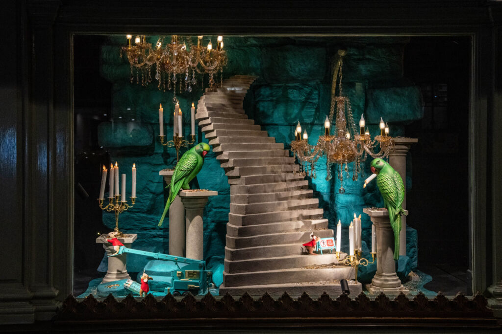 Mice at the foot of a stone staircase with two green parrots keeping watch for any danger