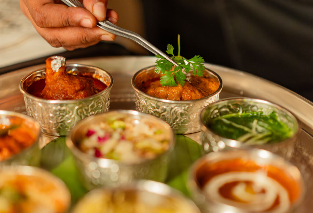 Jamavar Jaipur: Crafting Timeless Luxury Through Indian Culinary Art 13 Garnishing being placed on small dishes