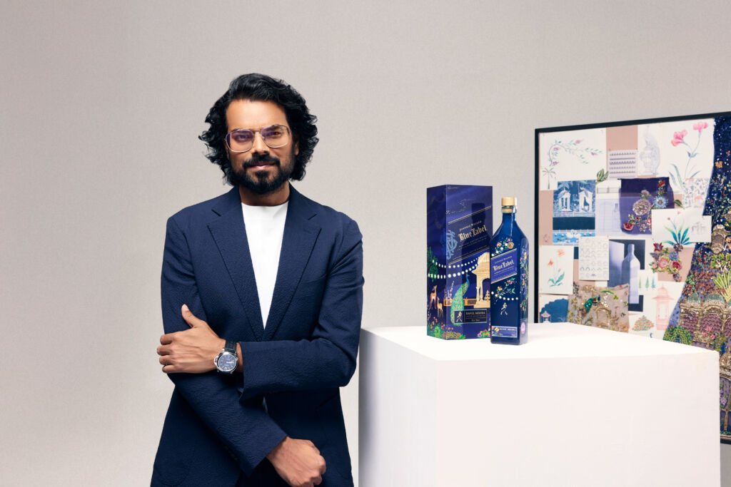The Luxurious Magazine Whisky Industry News Round-up for October 2025 18 Rahul Mishra next to a bottle of the brand's Blue Label