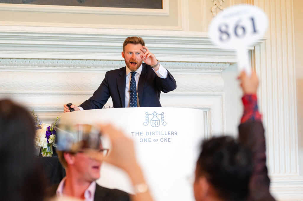 Johnny Fowle, Sotheby's Head of Spirits, fielding bids