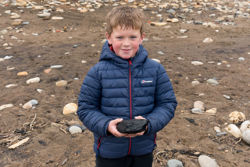 Luca Ball holding a piece of coal